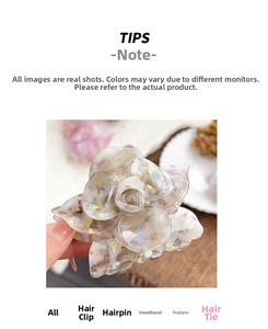 Detailed macro view of an elegant acetate rose hair claw with pearlescent marble texture