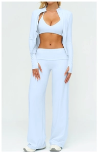 Three-piece light blue yoga set with long sleeve jacket, sports bra, and flared pants