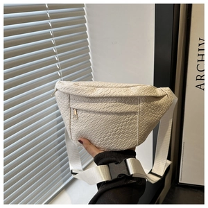 Detail of white woven faux leather belt bag with square pattern and zipper pocket