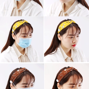 Detail of floral chiffon button headband showing ear protection feature for masks