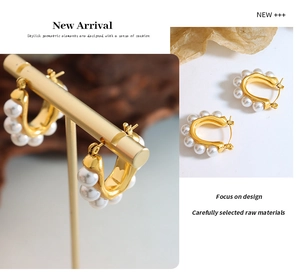 Detailed close-up of French vintage U-shaped earrings with gold setting and white pearls