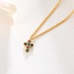 Golden stainless steel cross necklace with colorful crystal inlay on a white background