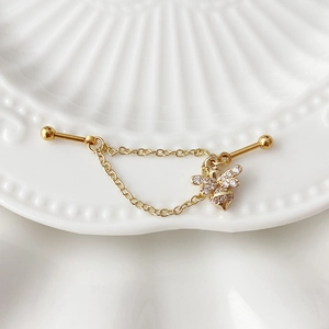 Golden industrial piercing barbell with delicate chain and white zircon bee pendant