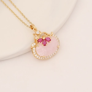 Elegant gold necklace with large pink oval stone and fuchsia teardrop gem pendants