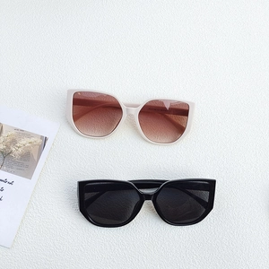 Oversized frame UV400 sunglasses in beige and black with wide temples and gradient lenses