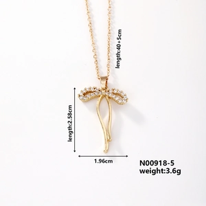 Detail shot of gold butterfly necklace with zircon settings and dimensions 2.58x1.96cm