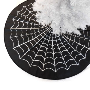 Detail of round black Christmas tree skirt with white spider web print for Halloween decor