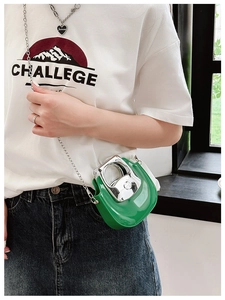 Detail of green jelly mini bag with silver metal handle and stylish chain strap