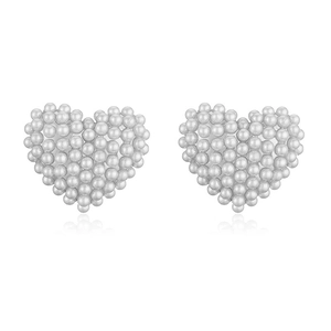Detailed view of elegant heart-shaped earrings featuring dense white pearl embellishments