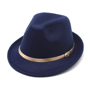 Detail of navy wool fedora with a textured gold metallic buckle on a leather band