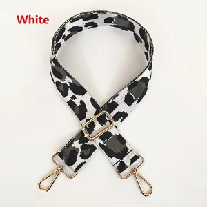 Detailed view of leopard print bag strap with golden metal hooks and adjustable buckle
