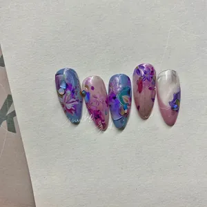 Detailed view of long almond press-on nails with purple and blue floral watercolor art