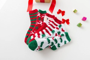 Detailed view of thick Christmas coral fleece socks featuring Santa and tree patterns