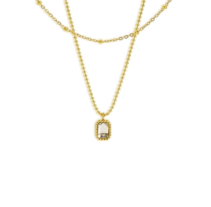 Detail of gold double-layered necklace with bead chain and rectangular clear pendant