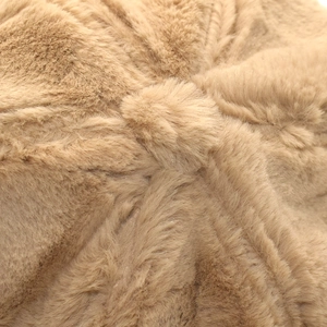 Close-up of the thick faux rabbit fur texture and top stitching on a camel winter hat