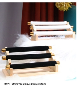 Three-tier velvet jewelry display stand with wooden base and elegant gold metal end caps