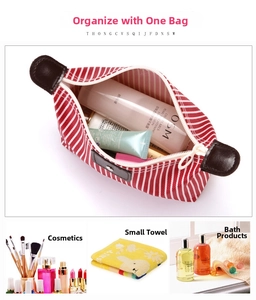 Detail view of large capacity striped waterproof cosmetic bag with leather handle and zipper