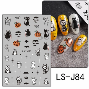 Detail of Halloween nail stickers featuring pumpkins, bats and ghosts on manicured nails