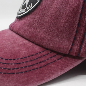 Close-up of the washed denim fabric and three-row stitching on the star baseball cap