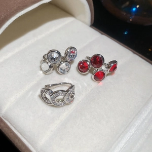 Close-up of zircon hollow rings with red gemstone accents on velvet jewelry box