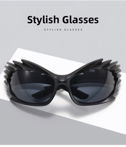 Detail view of black winged punk sunglasses with spiked edges and matte finish frame