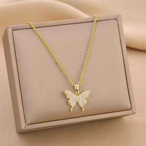 Elegant gold butterfly necklace with pavé cubic zirconia on a jewelry gift box