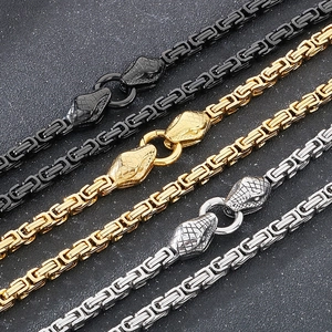 Detailed view of Byzantine snake head necklaces in black, gold, and silver stainless steel