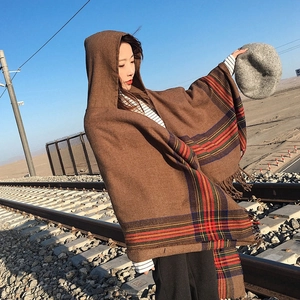 Plaid hooded poncho with tassels in brown, featuring striped cashmere-like knit patterns