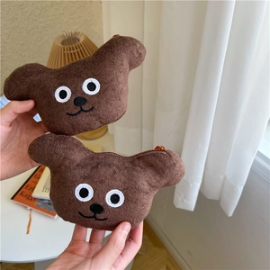 Detailed view of two cute brown teddy bear plush coin purses with zipper and fuzzy texture