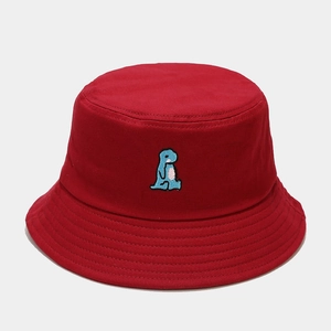 Close-up of cute blue dinosaur embroidery on deep red canvas bucket hat with stitching