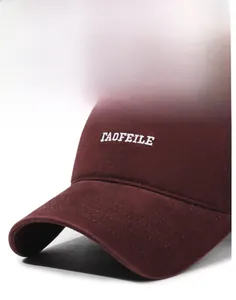Detail of burgundy cotton baseball cap with white letter embroidery and stitching