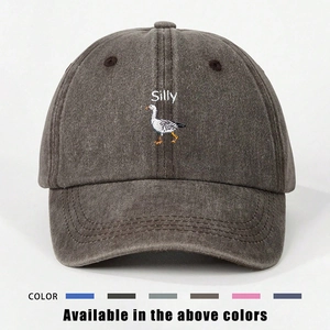 Detail of white Silly text and goose embroidery on washed dark gray cotton baseball cap