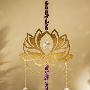 Macro shot of golden lotus suncatcher with natural amethyst stones and crystal prisms