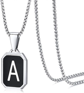 Close-up of a silver box chain necklace with a black octagonal letter A pendant
