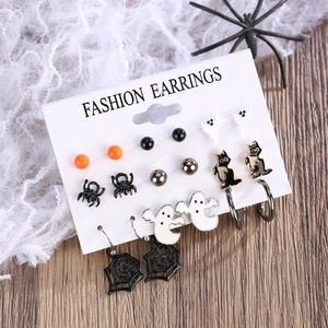 Detail of Halloween earring set with ghost, spider web and pumpkin charms on a display card