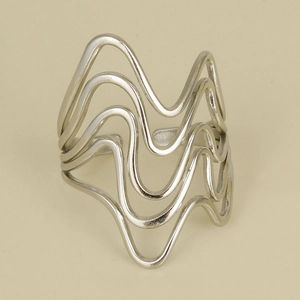 Macro detail of silver multi-layer wavy geometric ring with an adjustable open design