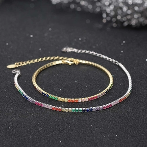 Close-up of rainbow zircon tennis bracelet with gold and silver plated bases on black background