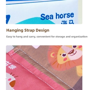 Close-up of soft baby cloth book featuring seahorse and lion animal prints with quilting