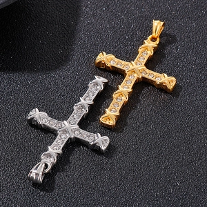 Detailed view of gold and silver cross pendants with shimmering inlaid rhinestones