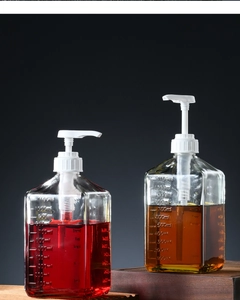 Detail of 1100ml glass syrup bottle with white pump and printed measurement scale