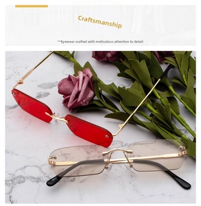 Detail of red and tawny rimless rectangular sunglasses with slim gold metal temples