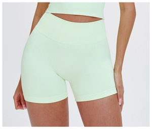 Close-up of mint green seamless high waisted yoga shorts with elastic compression fabric