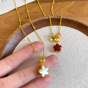 Close-up of elegant double-sided flower necklaces with red and white oil drip pendants