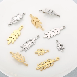 Detailed view of gold and silver leaf pendants with sparkling rhinestones for DIY jewelry