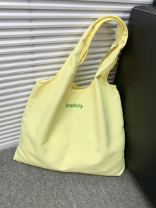 Simple light yellow canvas tote bag with green Simplicity print for travel and shopping