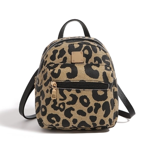 Detail of mini leopard print canvas backpack with black leather trim and gold hardware