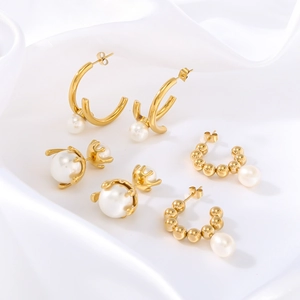 French vintage titanium steel C-shaped gold hoop earrings with pearls on white silk