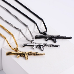 Macro shot of AK47 rifle necklaces in gold, silver and black stainless steel