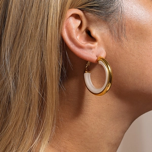 Chic 18K gold plated hoop earrings with white enamel finish worn by a model