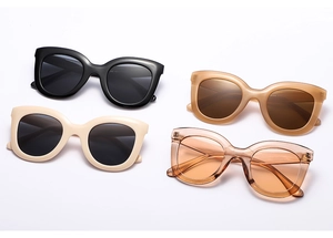 Selection of oversized cat-eye sunglasses in various colors on a clean white background